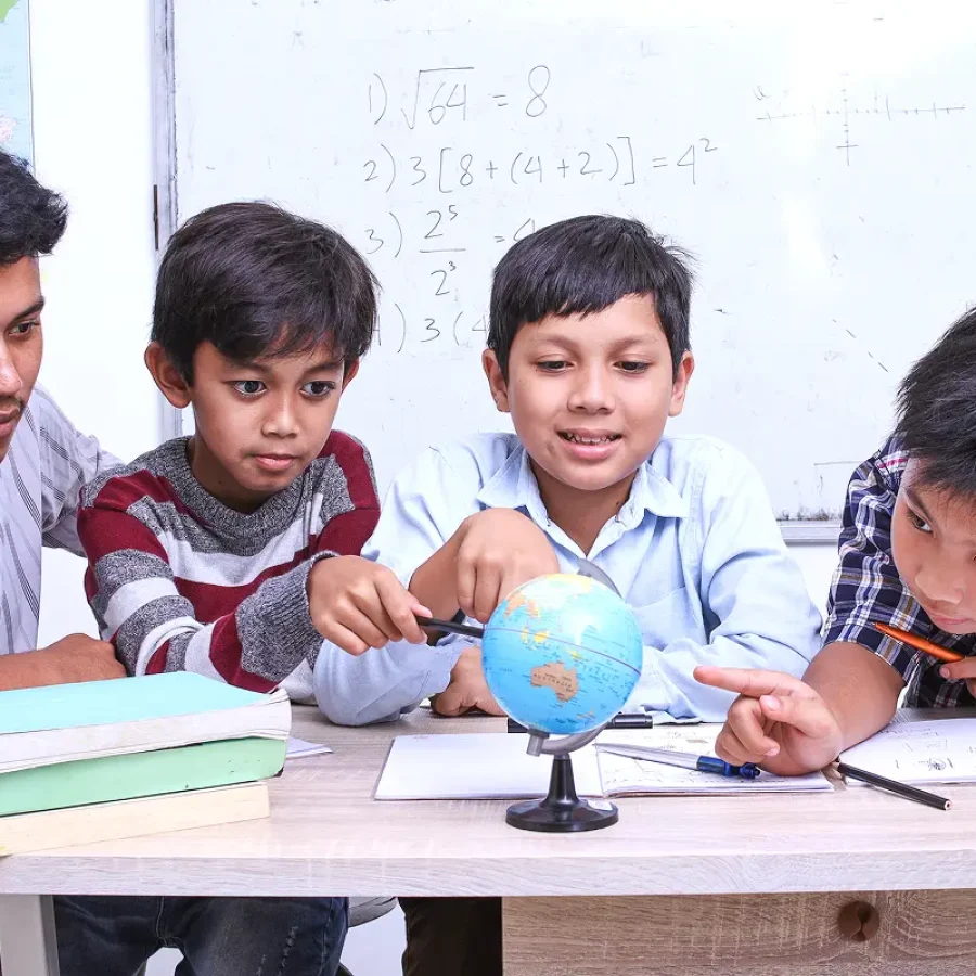 teacher-and-kids-discussing-globe-in-the-classroom